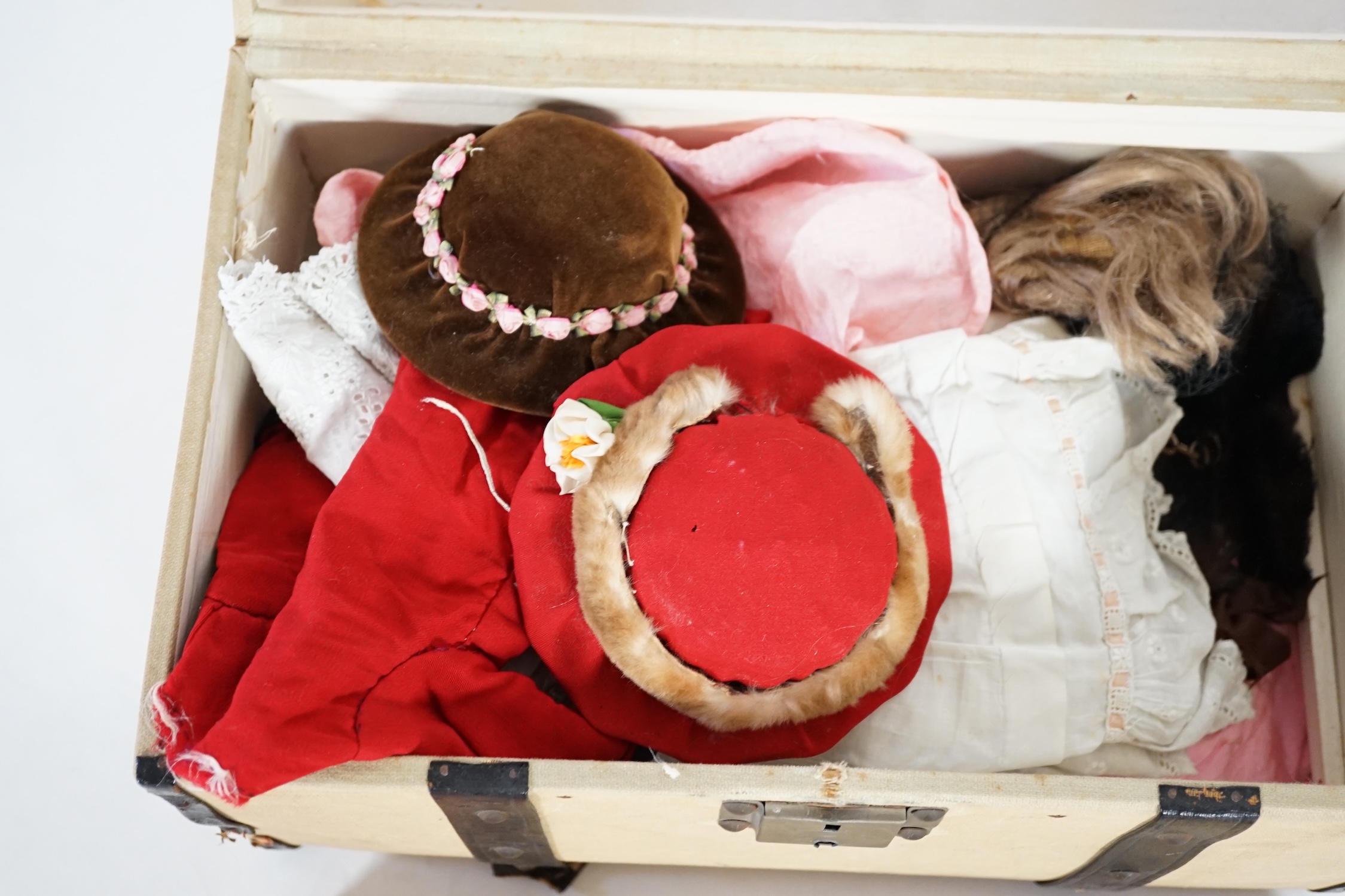 A doll's trunk with assorted vintage clothes, shoes and doll's accessories